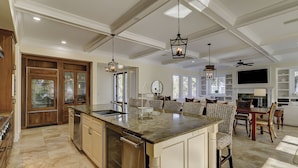 A spacious kitchen with a large island, wooden cabinetry, and pendant lighting. - Sunset Rentals | Capri 2 (Hilton Head Island)