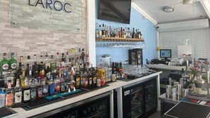 A bar area with a variety of liquor bottles and glasses on display. - Beach Front Studio For Rent in Freeport Grand Bahamas , Port Lucaya (Freeport)