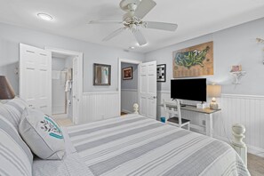 A bedroom with a bed, a television, a ceiling fan, and a map on the wall. - Fairway Dunes 27 - Screen Porch Golf Course View! (Isle of Palms)
