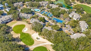 A residential area with multiple houses, a golf course, and a swimming pool. - Fairway Dunes 27 - Screen Porch Golf Course View! (Isle of Palms)