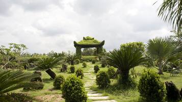 Un jardín con un sendero de piedra que lleva a un arco tradicional.