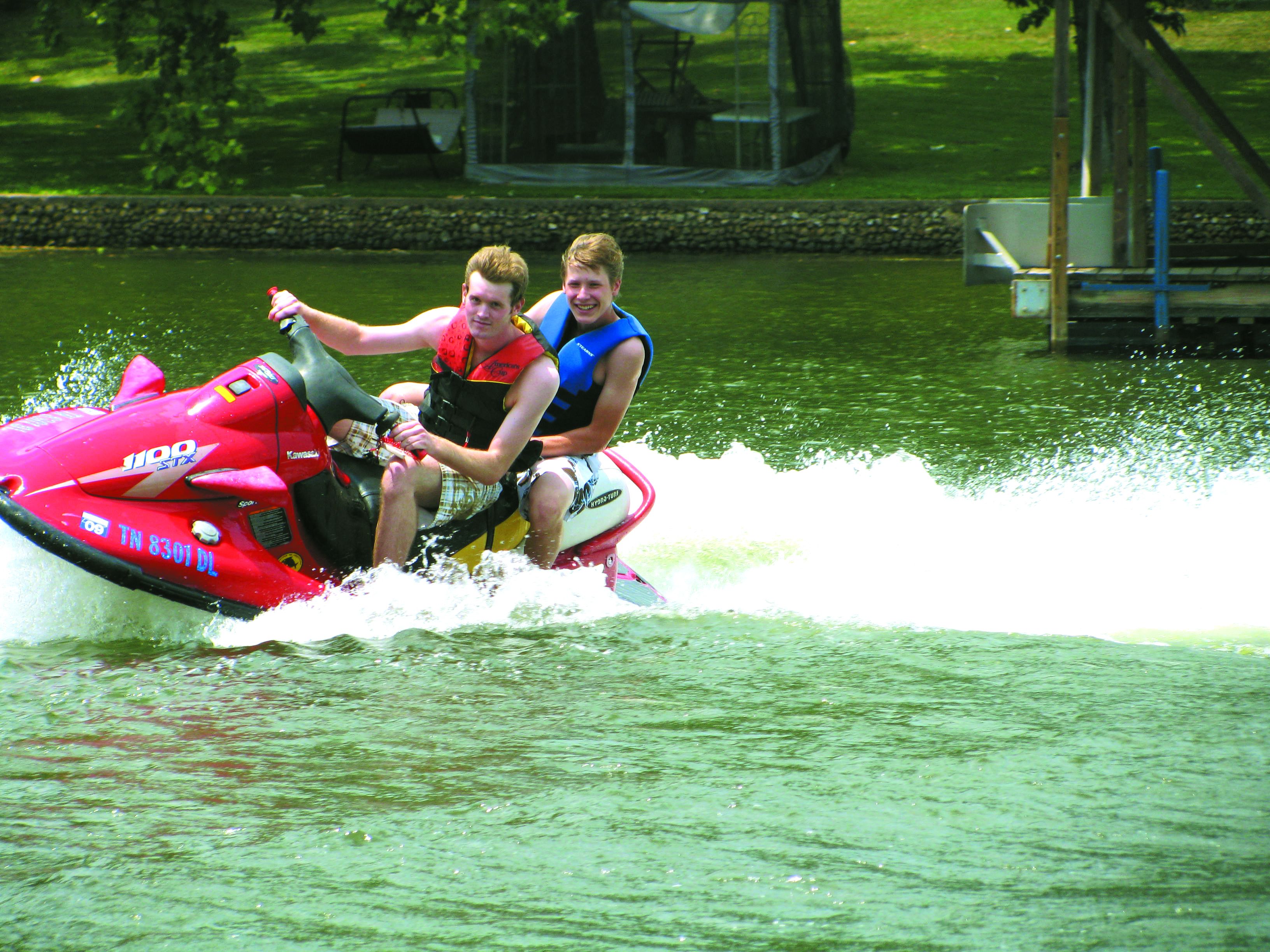 Two people on a red jet ski.