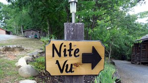 A wooden directional sign with the text "Nite Vu" and an arrow pointing to the right. - Nite Vu Cabin:A Light and Airy Retreat with Mountain Views, Hot Tub, and Jacuzzi (Sevierville)