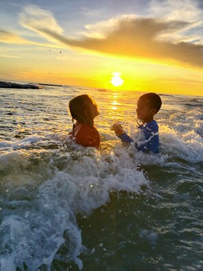 Two children playing in the water at sunset. - BIG AUGUST & SEPTEMBER DISCOUNT!!  4 bedroom, private pool BEACH GEAR PROVIDED!! (Port ST Joe)