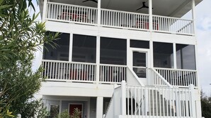 A two-story building with a balcony and a swimming pool.
