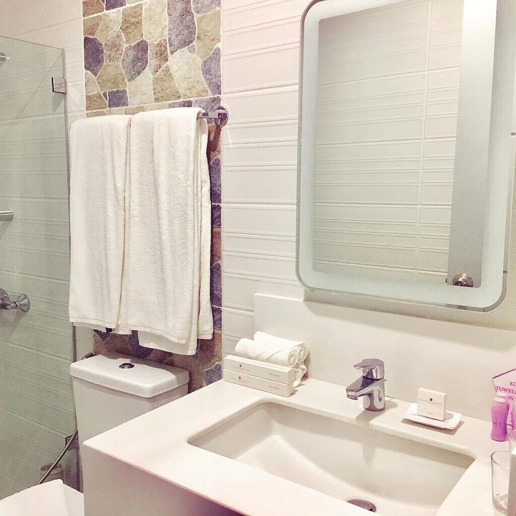deluxe room | bathroom | shower, rainfall showerhead, hair dryer, bidet