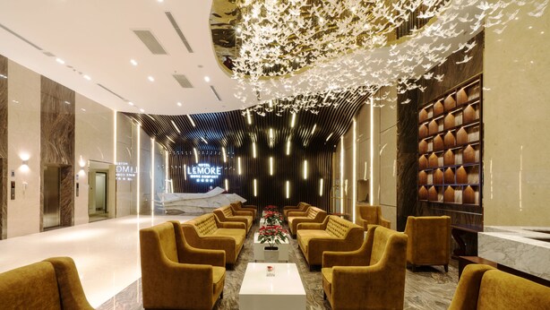 A hotel lobby with a central seating area, a reception desk, and a decorative ceiling. - LeMore Hotel Nha Trang (Nha Trang)