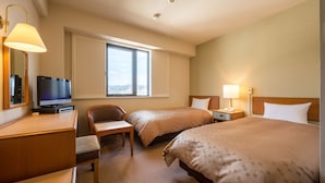 A hotel room with two beds, a desk with a television, a chair, a window with a view, and a lamp. - Pacific Hotel Shiroishi (Shiroishi)