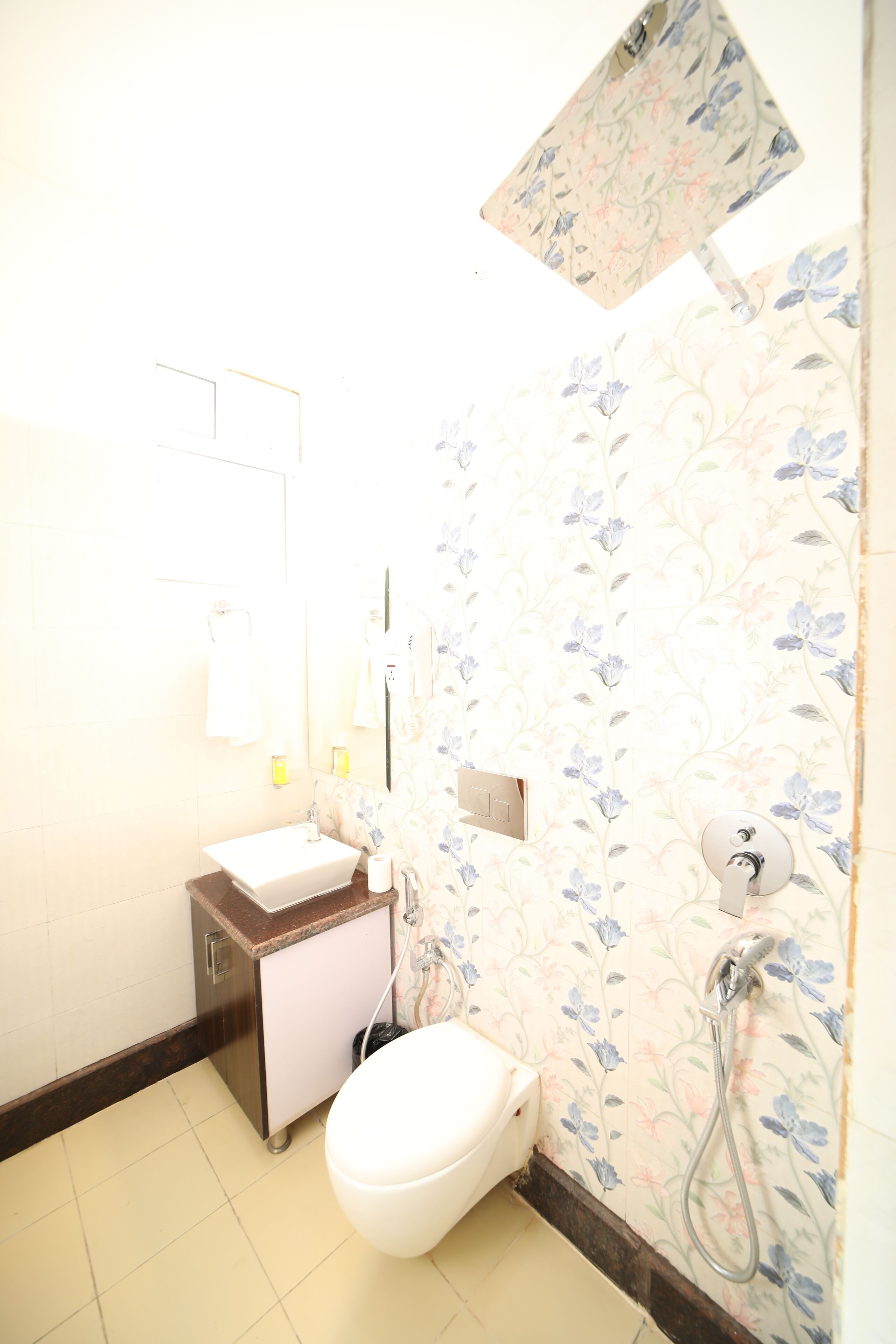 A bathroom with a toilet, sink, and shower.