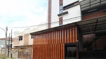 A building with a garage door, a visible entrance, and a clear sky.
