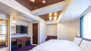 A hotel room with a large bed, a desk, a chair, a TV, and a wardrobe. - KOKO HOTEL Ikebukuro (Tokyo)