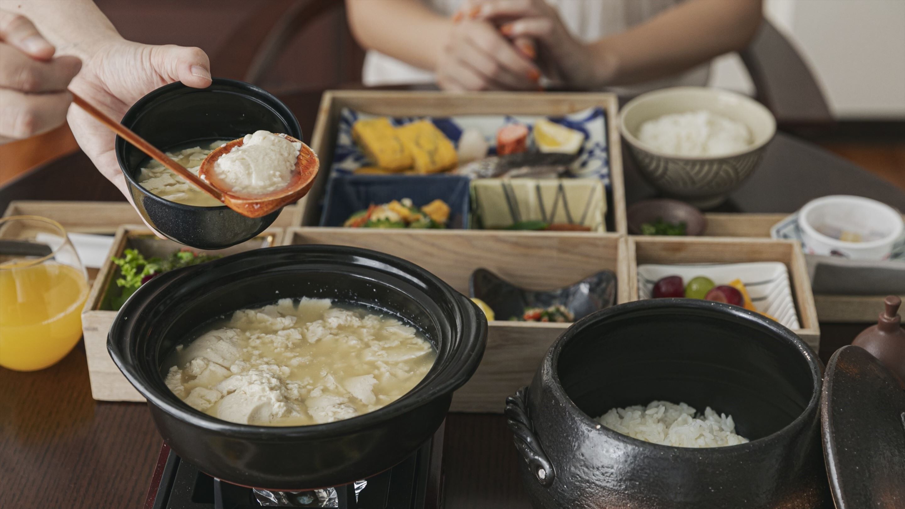 A traditional meal setup with various dishes and a hot pot.