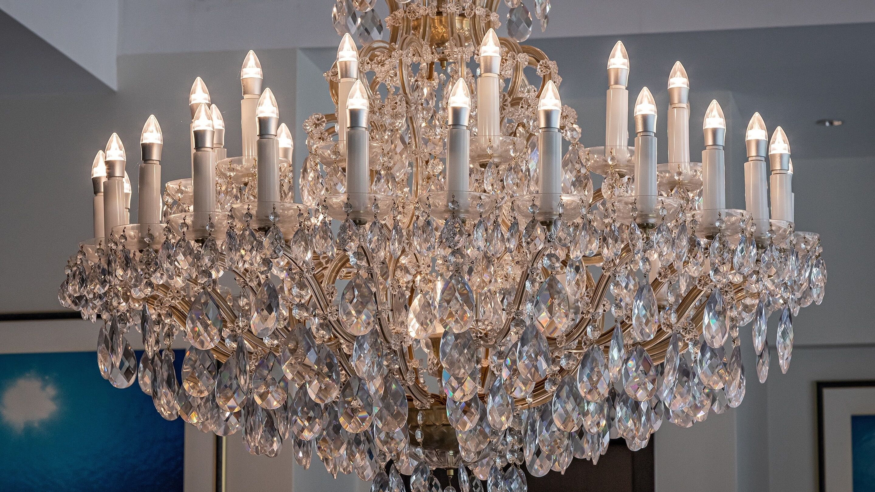 A chandelier with multiple candle-like lights and crystal decorations.