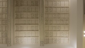 A wall with a grid of square panels, each with a unique design. - Navona Style (Rome)
