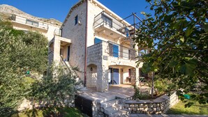 A two-story stone building with balconies, a pool, and a garden. - Olive Resort (Petrovac)