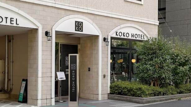 The entrance to Koko Hotel with clear signage, a modern design, and a visible pathway leading to the entrance. - KOKO HOTEL Shimbashi Onarimon (Tokyo)