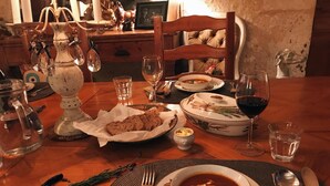 A dining table set with a bowl of soup, bread, and wine glasses. - Le Peyrail (Les Lèves-et-Thoumeyragues)