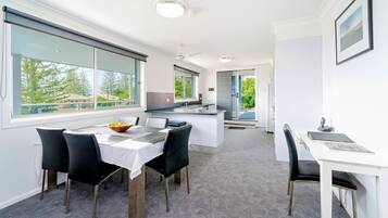 Escritorio, cortinas blackout y tabla de planchar con plancha