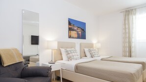 A modern hotel room with two beds, a sofa, a flat-screen TV, and a large window with curtains. - Holiday Home Aspalathos (Split)