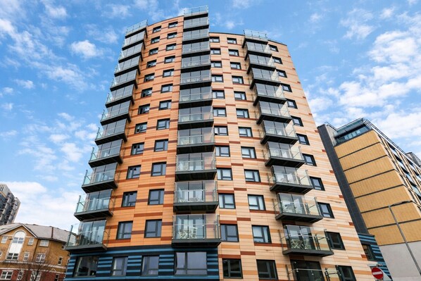 A multi-story residential building with a modern design, featuring balconies and large windows. - Roomspace Apartments -Vertex House (Croydon)