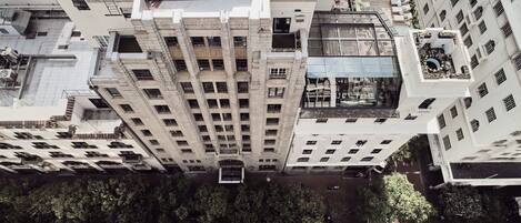 A high-rise building with multiple floors, large windows, and balconies.