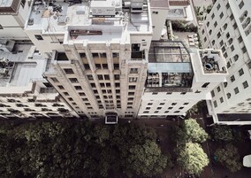 A high-rise building with multiple floors, large windows, and balconies.