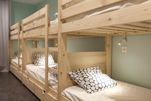 A bunk bed room with wooden frames and white bedding. - Balea Hostel (San Sebastián)