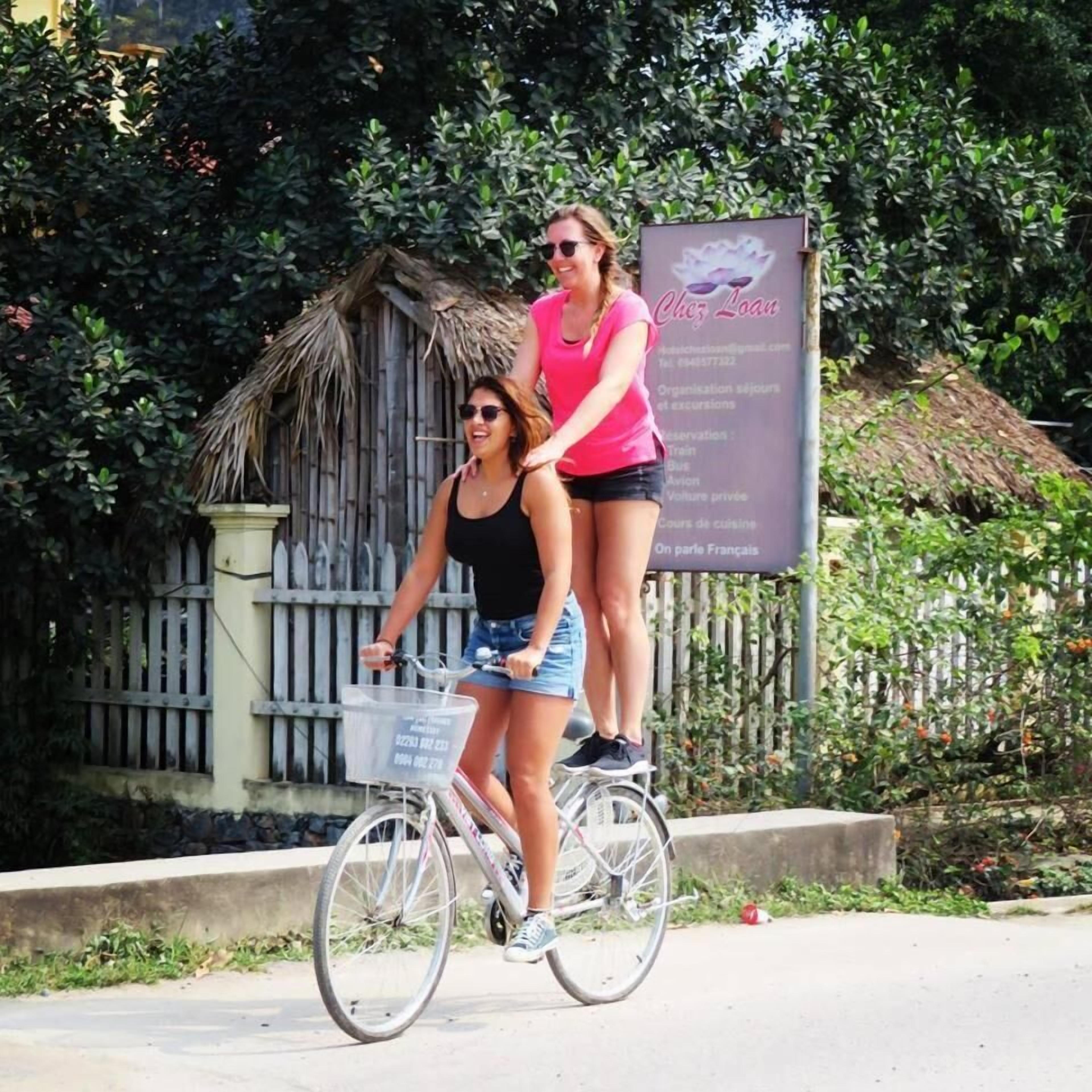 Two people riding a tandem bicycle.