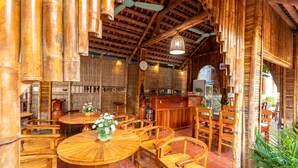 A restaurant with wooden furniture and bamboo decor.