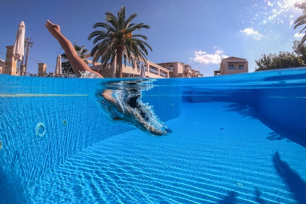 Seasonal outdoor pool, open 8:00 AM to 7:00 PM, pool umbrellas