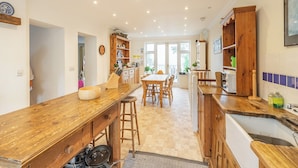 A kitchen with wooden countertops, a dining area, and a view of the outdoors. - 6 bedroom accommodation in St Margarets Bay, Dover (St Margarets Bay, Dover)
