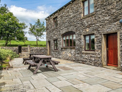 An 1800’s barn conversion with beams, exposed stonework and flagged floors.