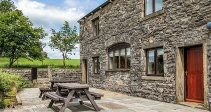An 1800’s barn conversion with beams, exposed stonework and flagged floors.