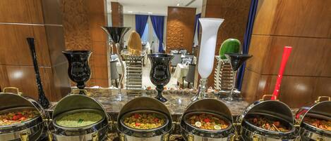 Un buffet con múltiples recipientes y utensilios.