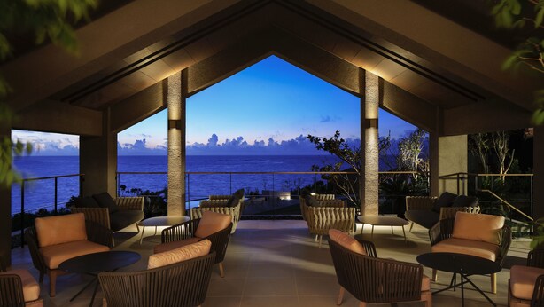A rooftop lounge with wicker furniture and a view of the sea. - The Hiramatsu Hotels & Resorts Ginoza (Ginoza)