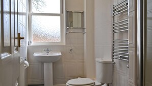 A bathroom with a pedestal sink, toilet, and a window. - 2 bedroom accommodation in Staindrop, near Barnard Castle (Staindrop, near Barnard Castle)