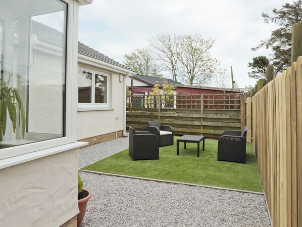 A patio with outdoor furniture, a small table, and a potted plant. - 3 bedroom accommodation in Southerness (Southerness)