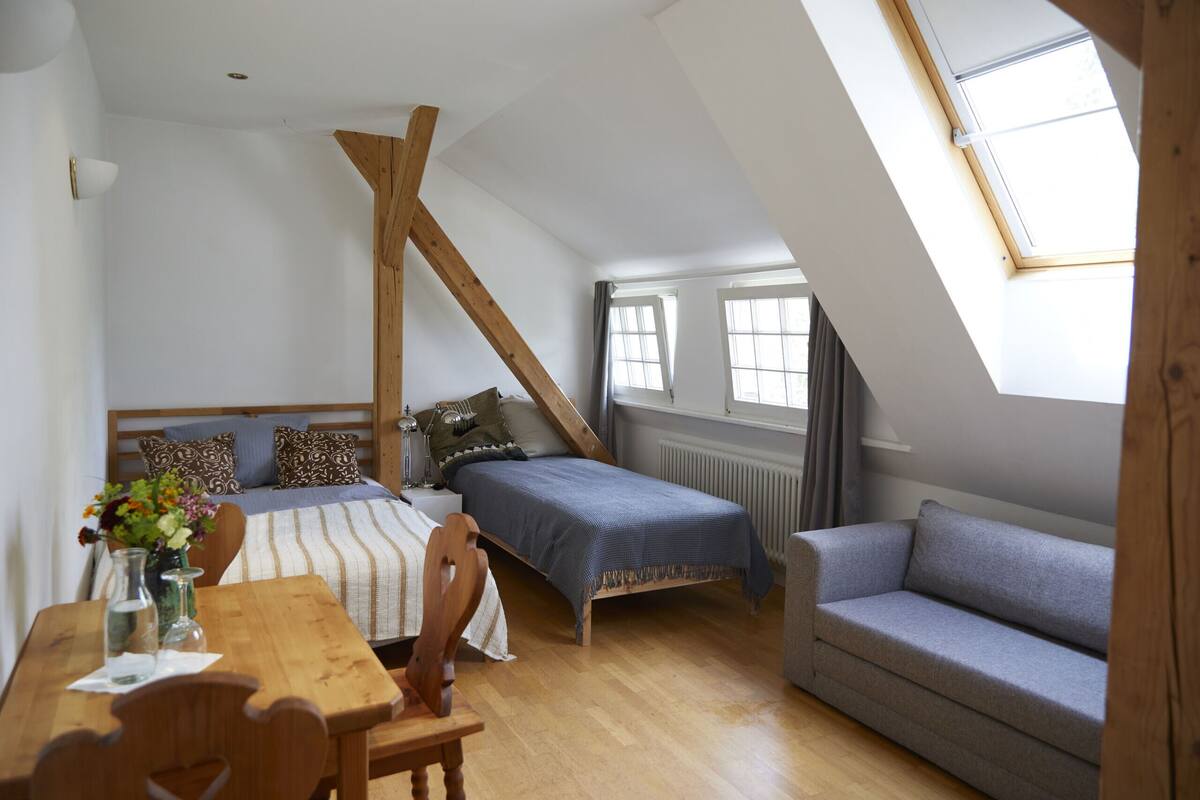 Premium bedding, desk, laptop workspace, blackout drapes