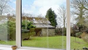 A view from a window of a stone building with a grassy yard and trees. - 2 bedroom accommodation in Croasdale, near Ennerdale Lake (Croasdale, near Ennerdale Lake)