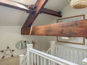 A staircase with white railings and a wooden beam ceiling. - Grain End Cottage is set in large landscaped gardens. (Sawdon, near Scarborough)