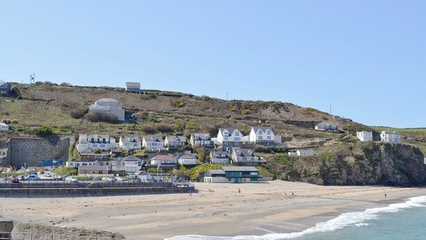 A coastal town with houses on a hillside, a beach, and a pier. - 2 bedroom accommodation in Carn Brea, Redruth (Carn Brea, Redruth)