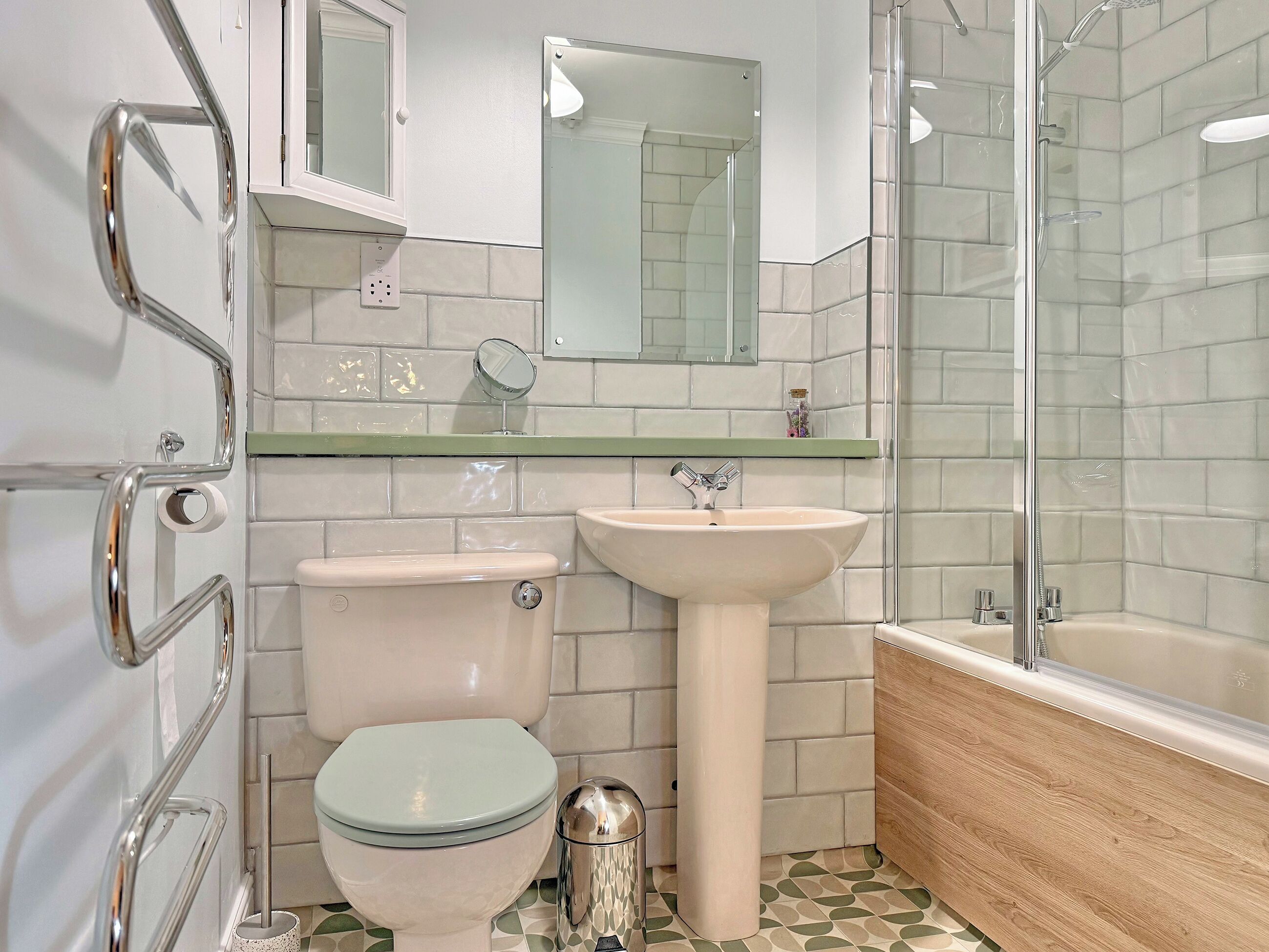A bathroom with a toilet, sink, and shower.