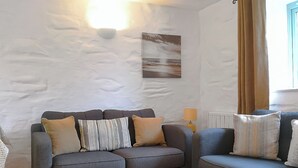 A living room with a grey sofa set, a lamp, and a painting on the wall. - 3 bedroom accommodation in Mawla, near Porthtowan (Mawla, near Porthtowan)
