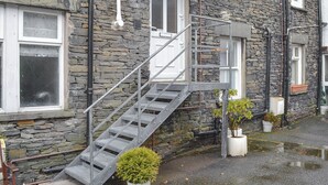 A stone building with a metal staircase leading to a door marked "Little Nook 9". - 1 bedroom accommodation in Ambleside (Ambleside)