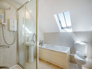 A modern bathroom with a glass-enclosed shower, a freestanding bathtub, and a toilet with a towel on top. - 2 bedroom accommodation in near Castleton (near Castleton)