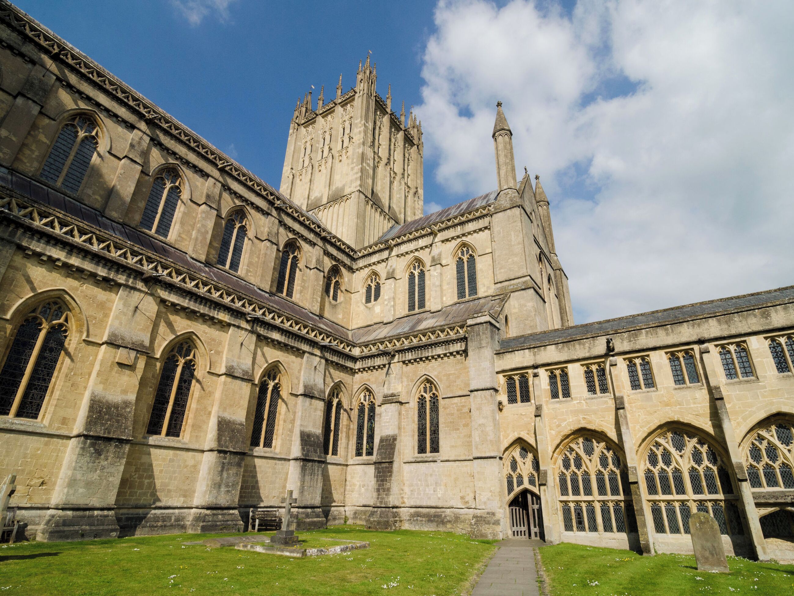 A historic building with large arched windows and a prominent tower.