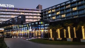 A modern hotel with a prominent "Hamilton" sign, a glass facade, and a well-lit entrance area. - Hamilton Conference Hotel Spa & Wellness (Swinoujscie)