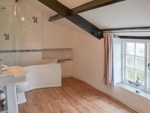A bathroom with a bathtub, a sink, and a shower. - 3 bedroom accommodation in Trebarwith, Delabole (Trebarwith, Delabole)