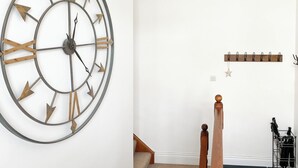 A room with a large wall clock, a coat rack, and a staircase. - 3 bedroom accommodation in Keswick (Keswick)
