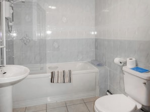 A bathroom with a bathtub, a sink, and a toilet.